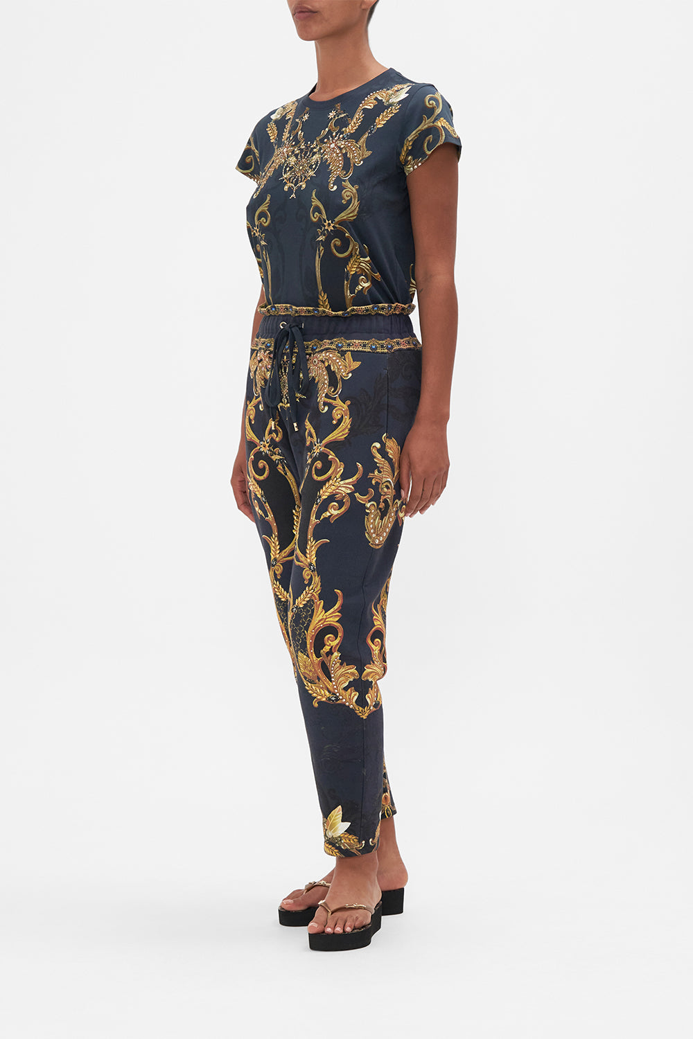 Side view of model wearing CAMILLA trackpants in Moonlight Melodies print